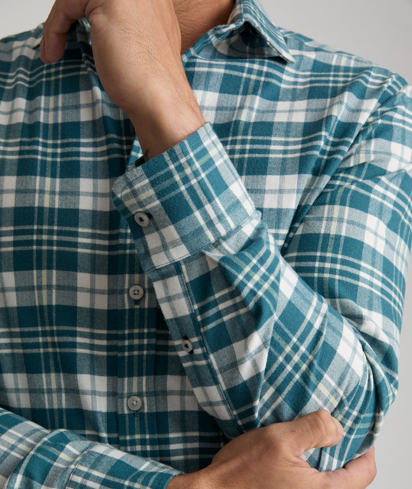 Model is wearing UNTUCKit Wrinkle-Free Performance Flannel Ferney Shirt in teal plaid.