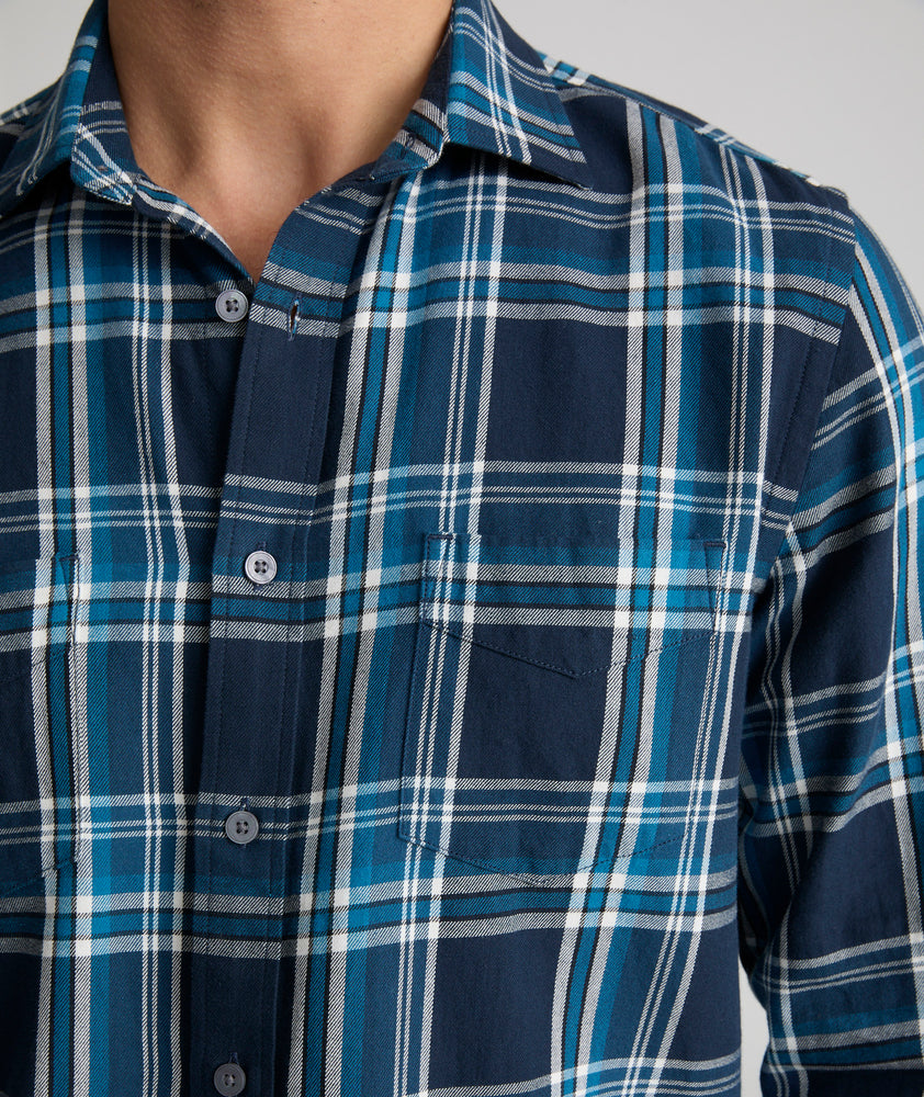 Model is wearing UNTUCKit Plaid Flannel Shirt in Navy & Light Blue Plaid | Fair Traide Certified™ . 