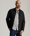 Model is wearing UNTUCKit Gardner jacket in black beauty. 