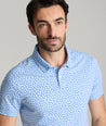 Model is wearing UNUCKit George printed wrinkle-free polo in ultramarine. 