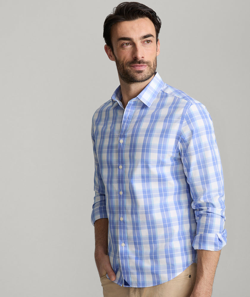 Model is wearing UNTUCKit Gillingham wrinkle-free shirt in blue. 