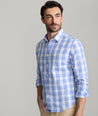 Model is wearing UNTUCKit Gillingham wrinkle-free shirt in blue. 