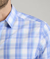 Model is wearing UNTUCKit Gillingham wrinkle-free shirt in blue. 