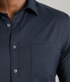 Model is wearing UNTUCKit gironde shirt in black. 