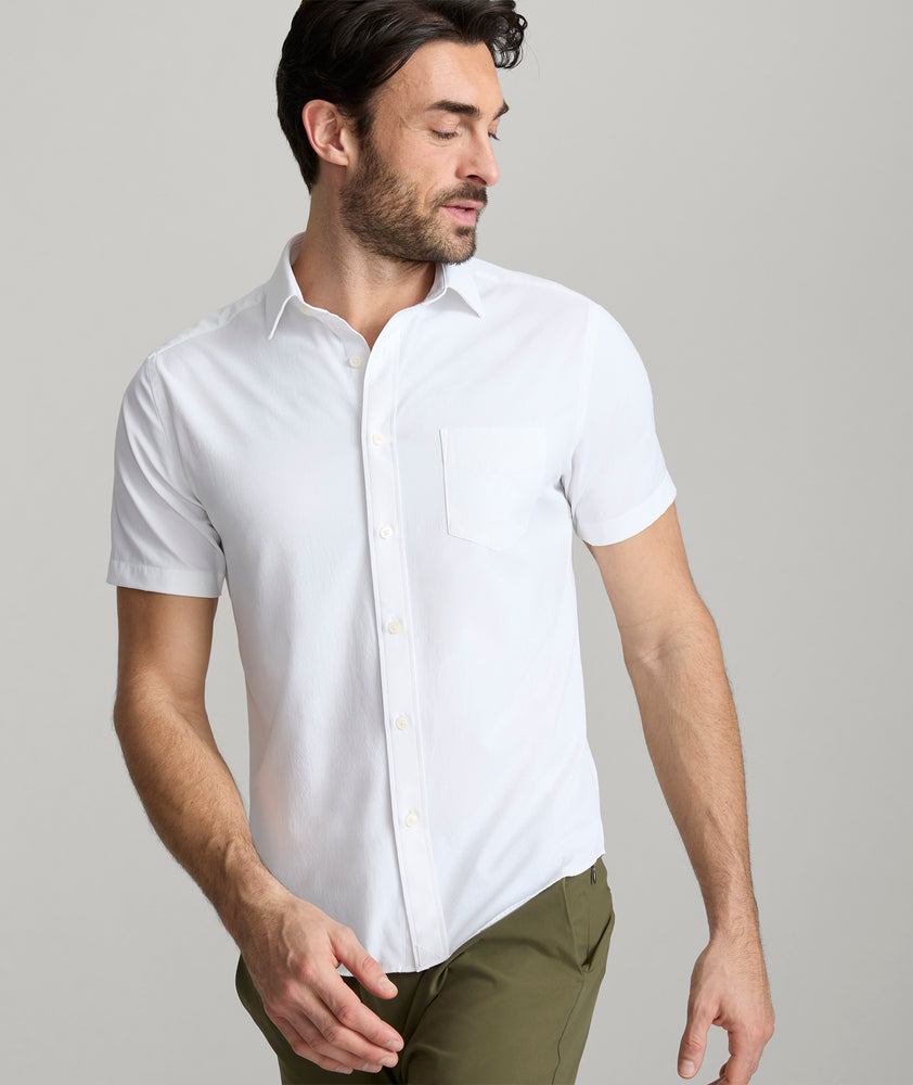 Model wearing an UNTUCKit White Wrinkle-Free Performance Short Sleeve Gironde Shirt