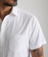 Model wearing an UNTUCKit White Wrinkle-Free Performance Short Sleeve Gironde Shirt