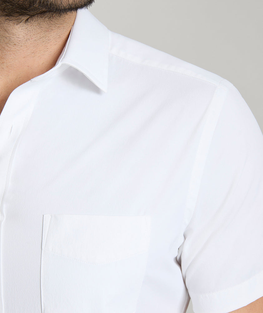 Model wearing an UNTUCKit White Wrinkle-Free Performance Short Sleeve Gironde Shirt