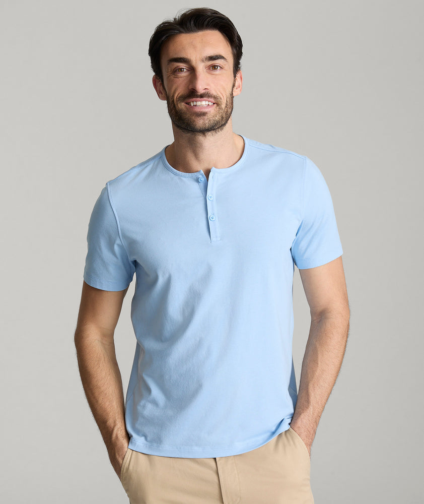 Model is wearing UNTUCKit glera tencel Placid Blue henley. 