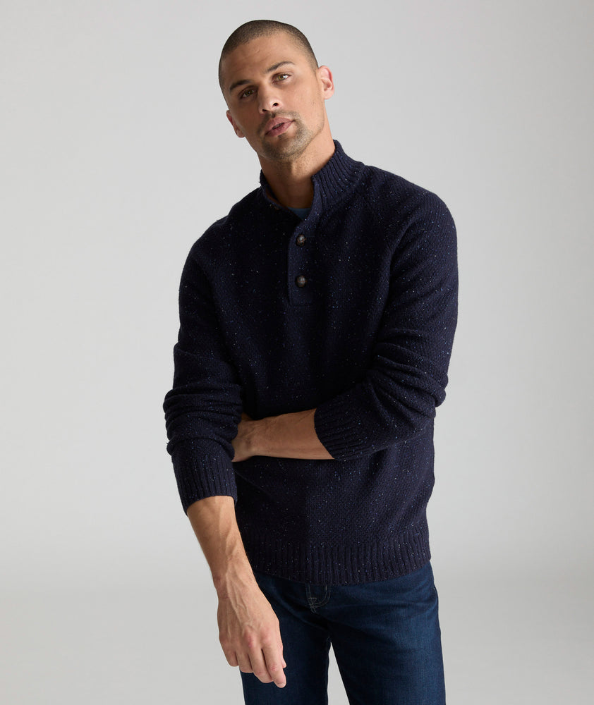 Model is wearing UNTUCKit Button-Neck Donegal Sweater in navy.