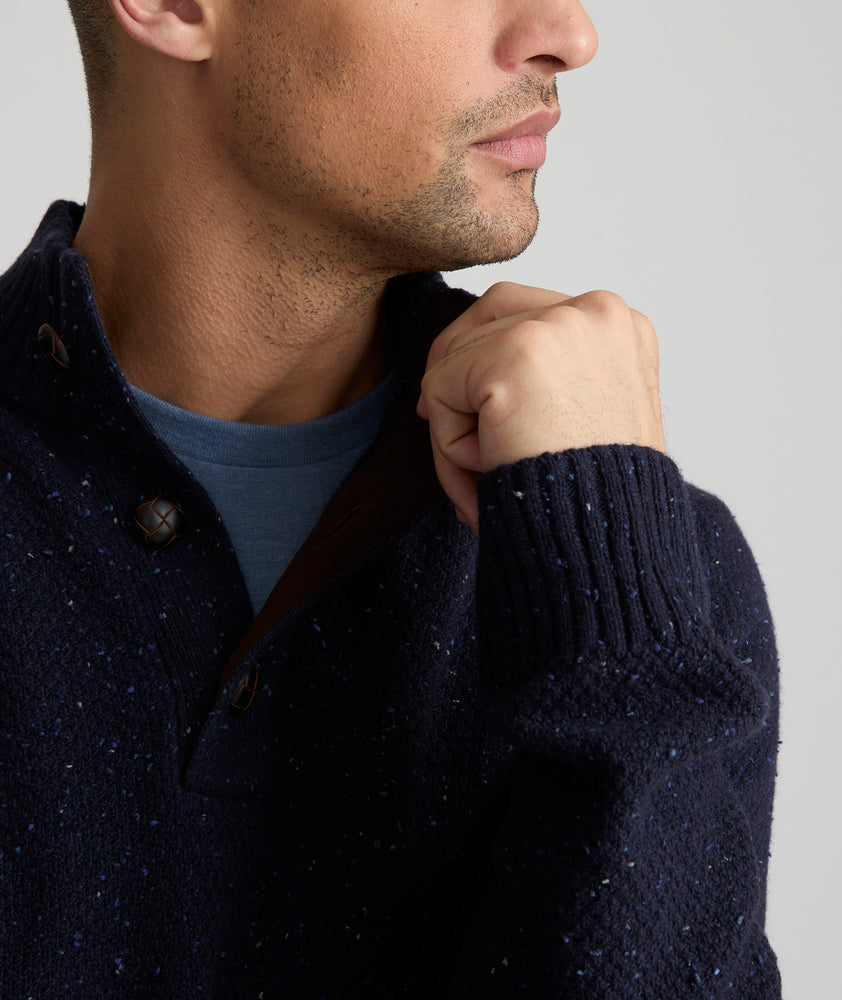 Model is wearing UNTUCKit Button-Neck Donegal Sweater in navy.