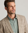 Model is wearing UNTICKit Italian Wool Blend Graydy Sport Coat in Tan Windowpane Check. 