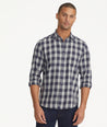 Model is wearing UNTUCKit gray and navy Buffalo check flannel.