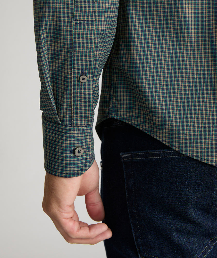 Model is wearing UNTUCKit Harris shirt in green and navy small check. 