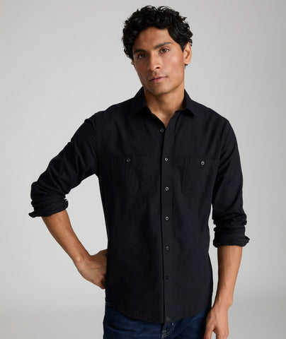 Model is wearing Flannel Hemsworth Shirt in Black Herringbone.