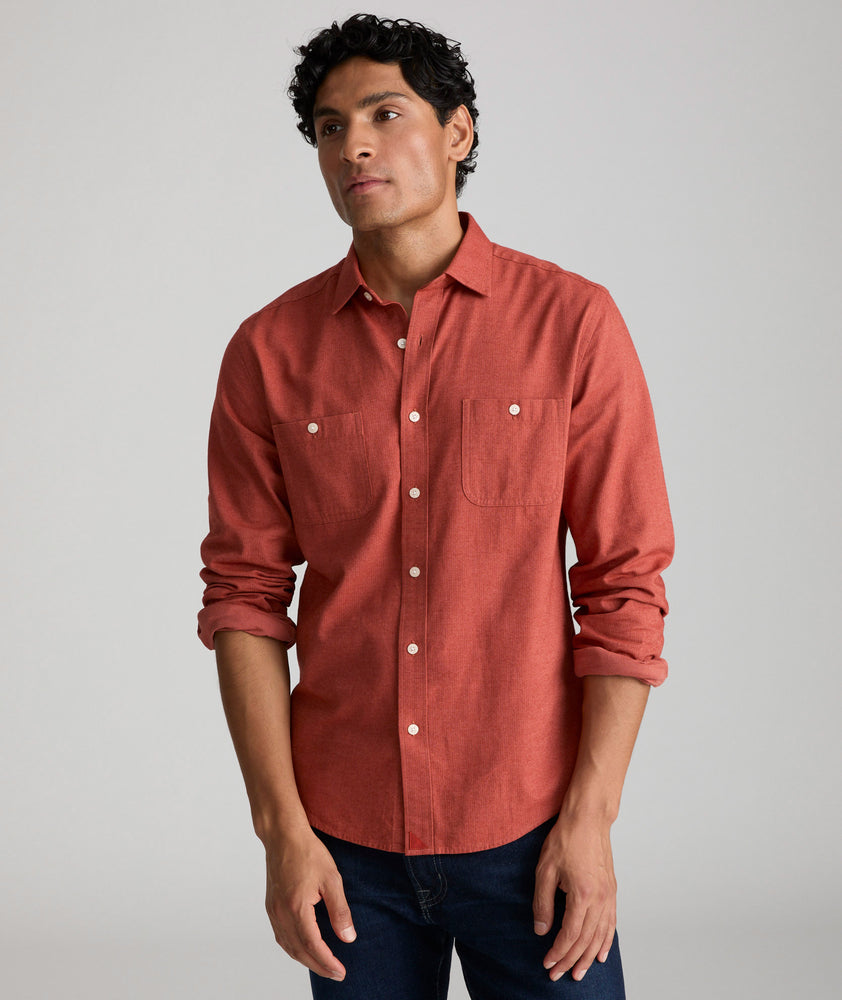 Model is wearing UNTUCKit  Flannel Hemswoth Shirt in burnt red. 