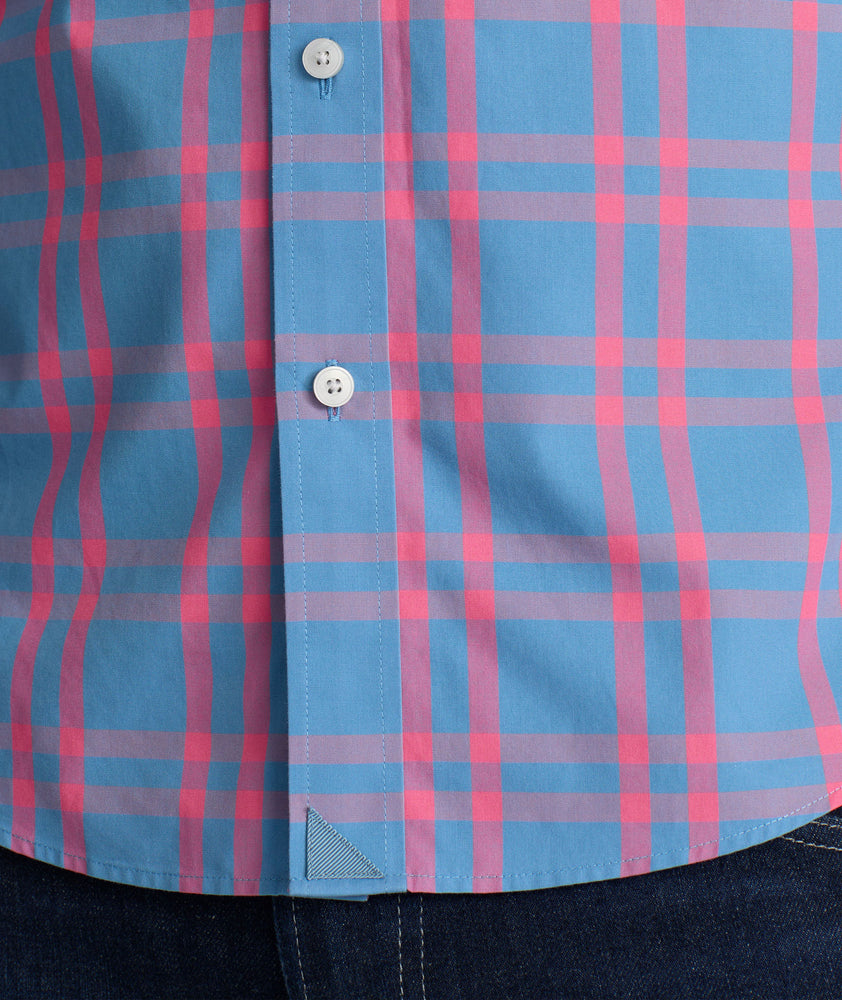 Model is wearing UNTUCKit Howard shirt in navy with pink checks. 