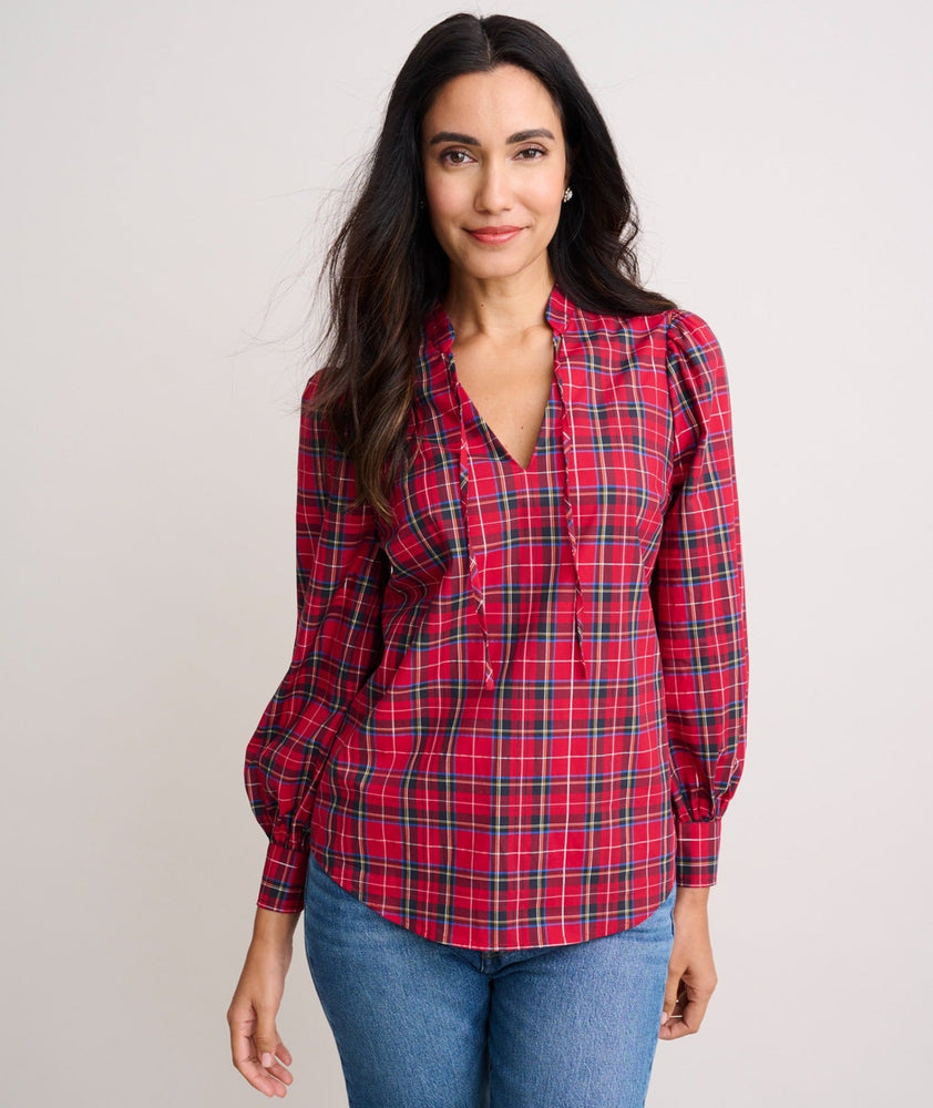 Model is wearing UNTUCKit Joy shirt in red plaid. 