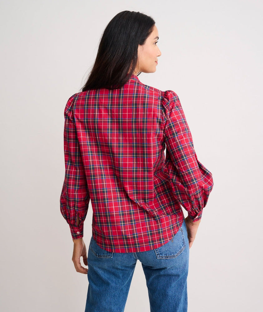 Model is wearing UNTUCKit Joy shirt in red plaid. 