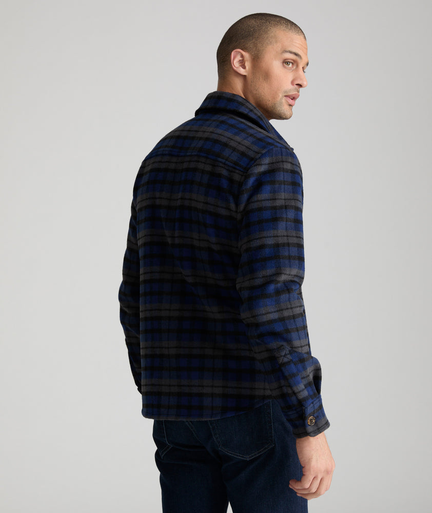 Model is wearing UNTUCKit Lagrein in black plaid. 