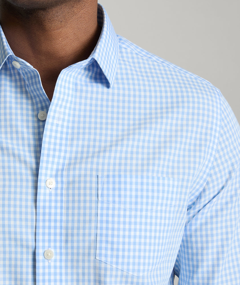 Model is wearing UNTUCKit Lawrence wrinkle free in light blue gingham. 