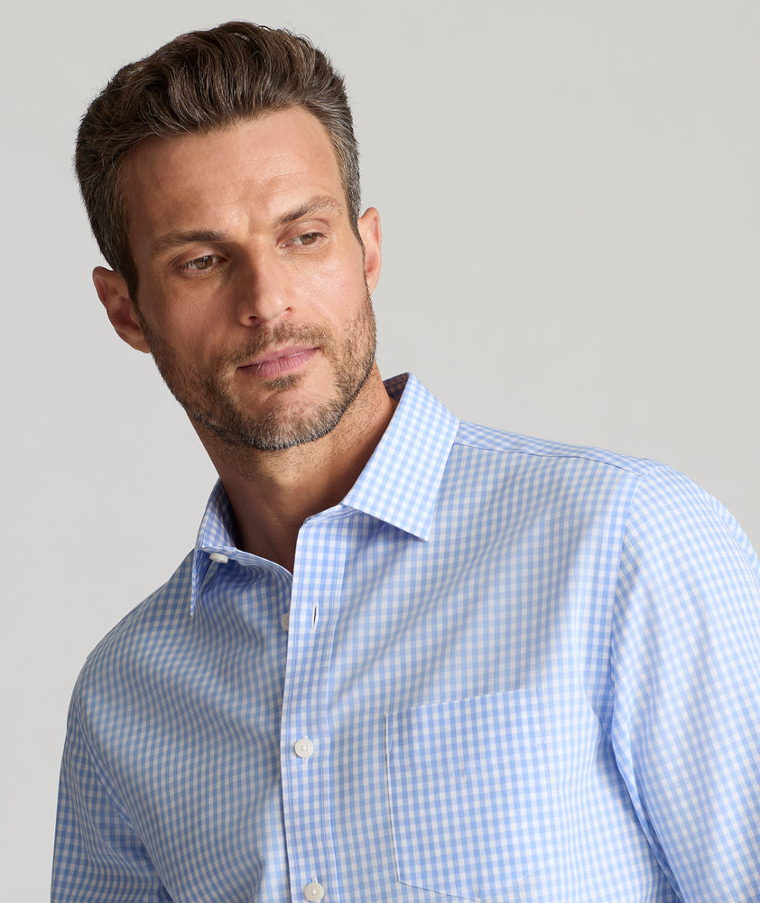 Model is wearing UNTUCKit Lawrence wrinkle free in light blue gingham. 