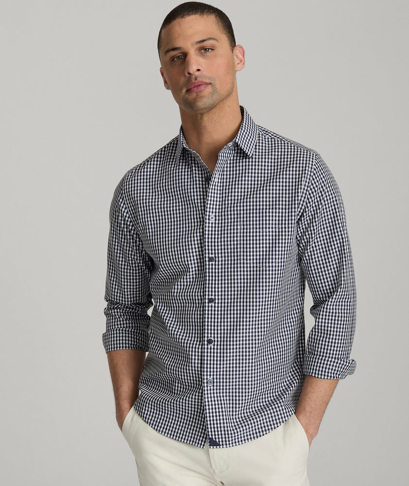 Model is wearing UNTUCKit Lawrence wrinkle free in navy blue gingham. 