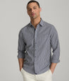 Model is wearing UNTUCKit Lawrence wrinkle free in navy blue gingham. 