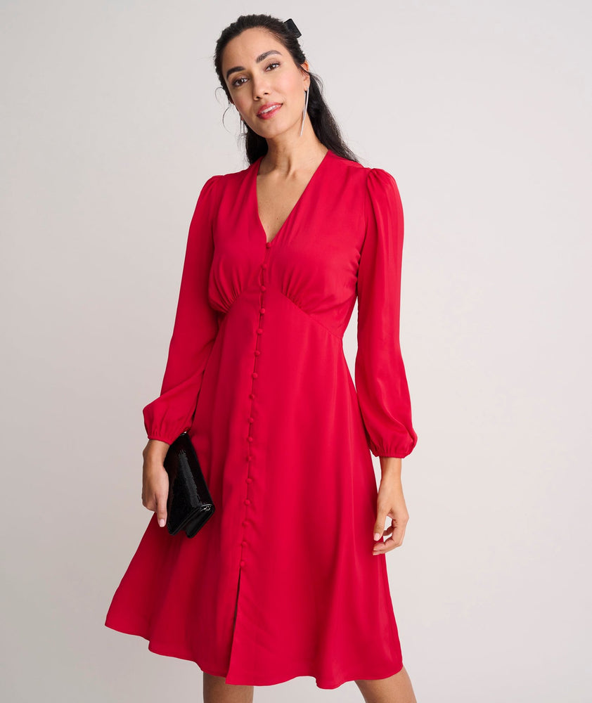 Model is wearing UNTUCKit Malorie dress in red. 