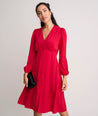 Model is wearing UNTUCKit Malorie dress in red. 