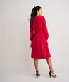 Model is wearing UNTUCKit Malorie dress in red. 