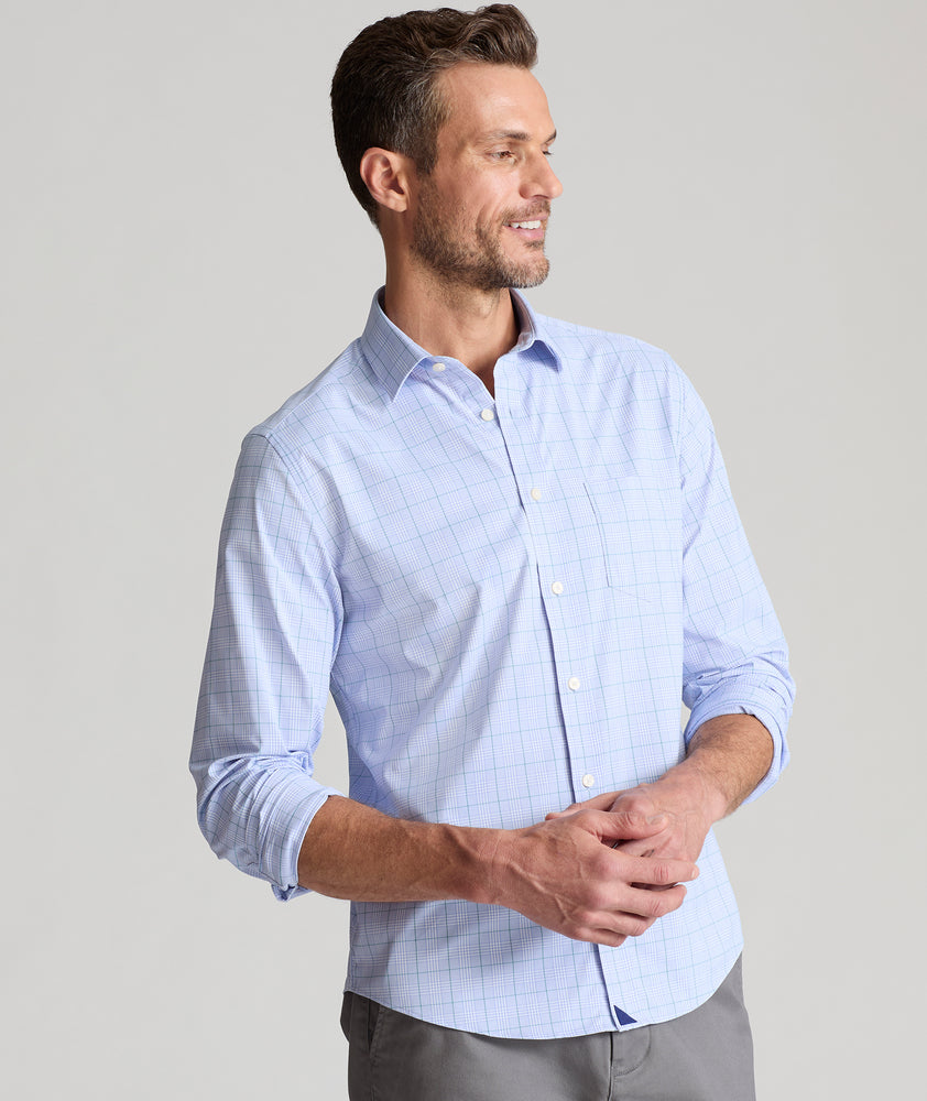 Model is wearing UNTUCKit Mason performance shirt in light blue check. 