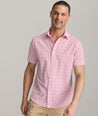 Model is wearing UNTUCKit Mavrud pink short sleeve button down.