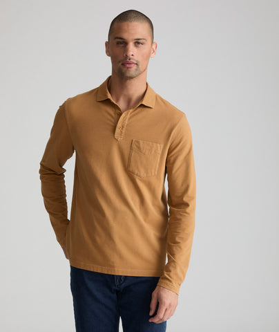 Model is wearing UNTUCKit long sleeve mays garment dyed polo in cathay spice.