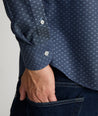 Model is wearing UNTUCKit Mcbride Wrinkle-free shirt in printed chambray. 