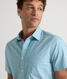 Model is wearing UNTUCKit Mccoy cotton short sleeve shirt in teal grocircle print