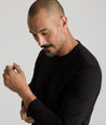 Model is wearing UNTUCKIt Merille long sleeve Tencel Tee in black.