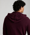 Model is wearing UNTUCKit Merino Hoodie in solid Burgundy. 