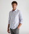 Model is wearing UNTUCKit Moore shirt in blue, orange and pink check.