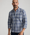 Model is wearing UNTUCKit Flannel Morenillo Shirt in Heathered Blue Plaid