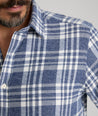 Model is wearing UNTUCKit Flannel Morenillo Shirt in Heathered Blue Plaid.