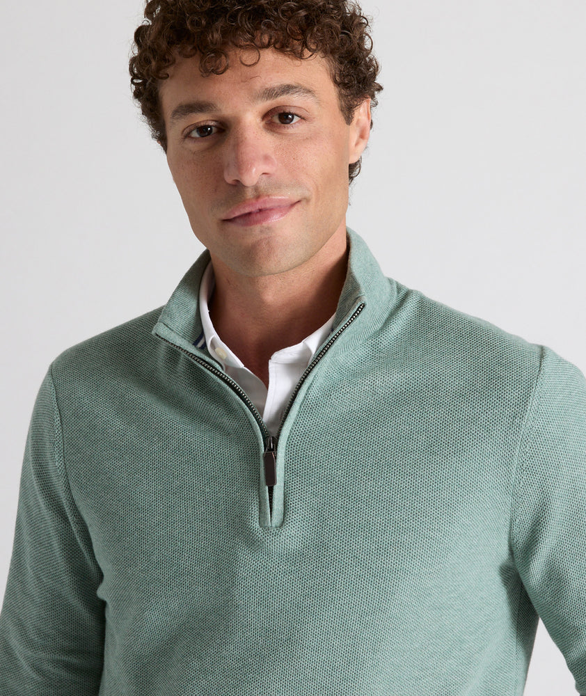 Model is wearing UNTUCKit Newbury cotton quarter zip in heather green.