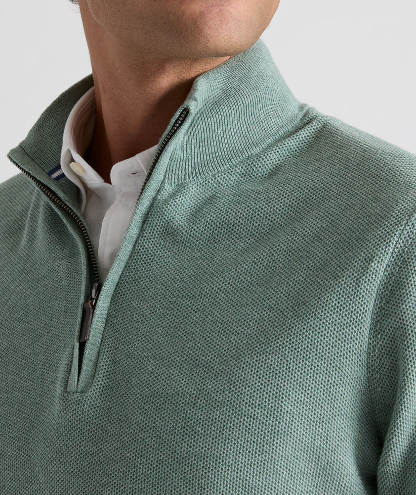 Model is wearing UNTUCKit Newbury cotton quarter zip in heather green.