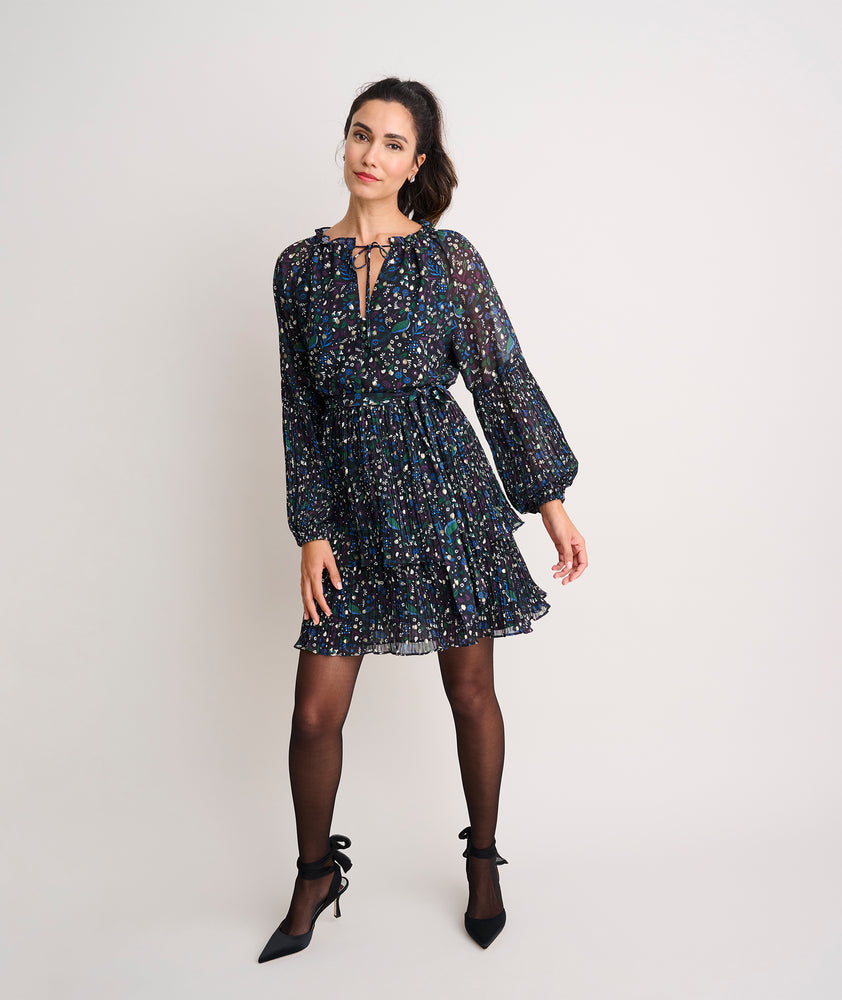 Model is wearing UNTUCKit Paloma dress in black print. 