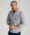 Model is wearing UNTUCKit Perez performance Flannel in gray grounded windowpane. 