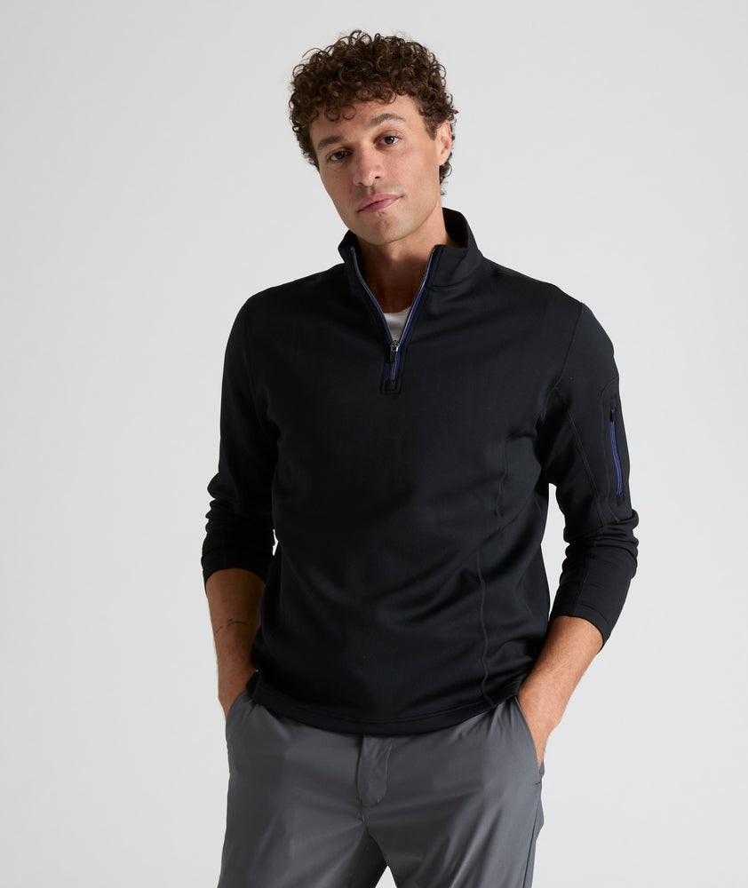 Model wearing a  Performance Quarter-Zip in black.