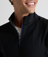 Model wearing a  Performance Quarter-Zip in black.