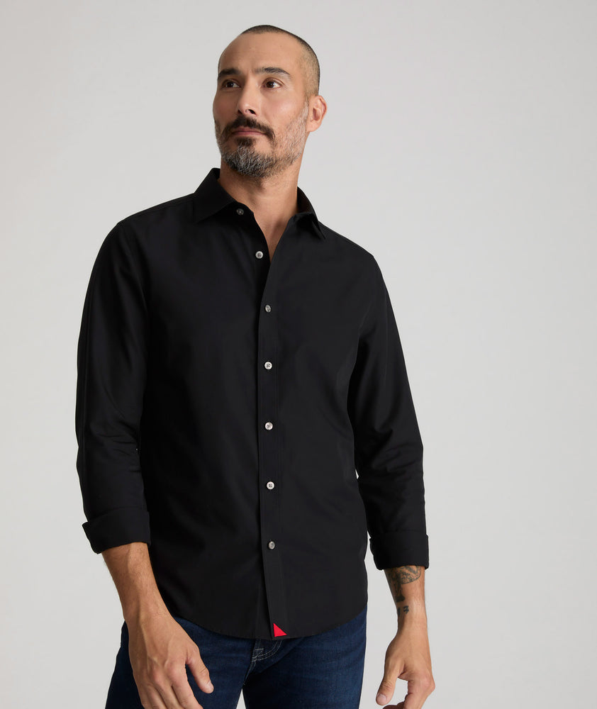 Model is wearing UNTUCKit Reed shirt in true black. 