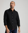 Model is wearing UNTUCKit Reed shirt in true black. 