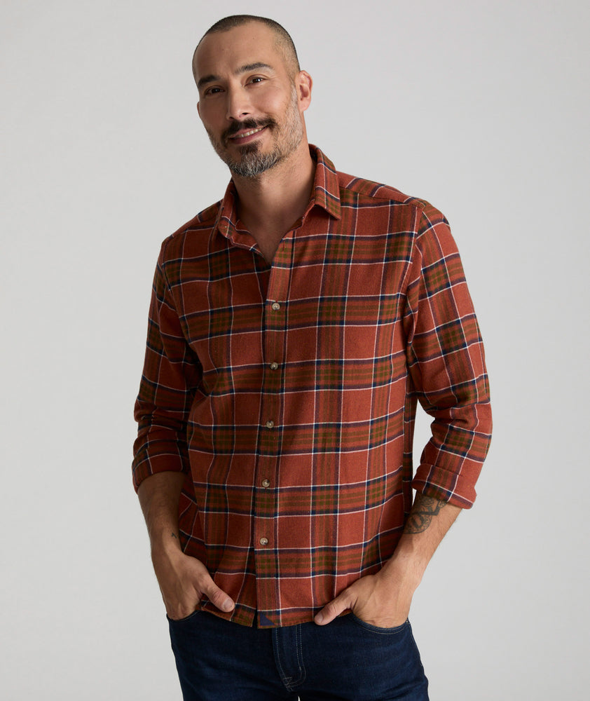 Model is wearing UNTUCKit Flannel Regner Shirt in Burnt Red Plaid.