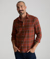 Model is wearing UNTUCKit Flannel Regner Shirt in Burnt Red Plaid.